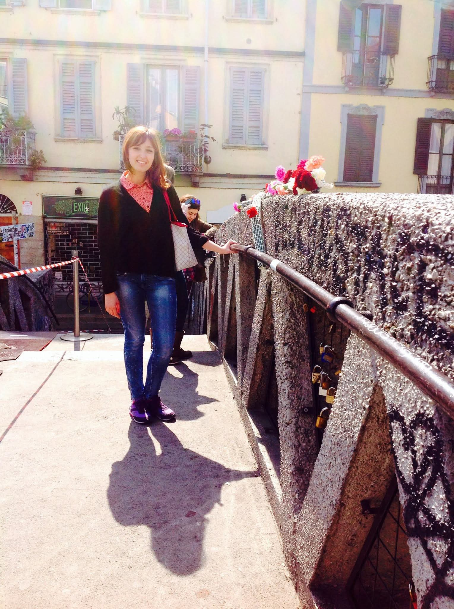 a girl standing in Navigli bridge, in Milano